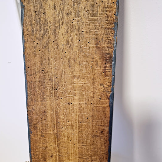 Back of antique Swedish wall hook showing hand-worked wood and old woodworm holes