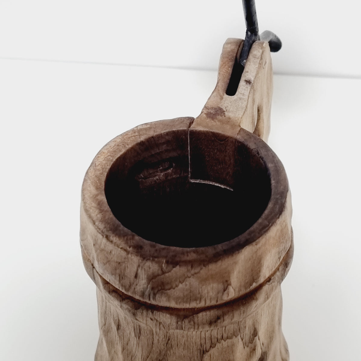 Dark patinated interior of carved wooden tankard