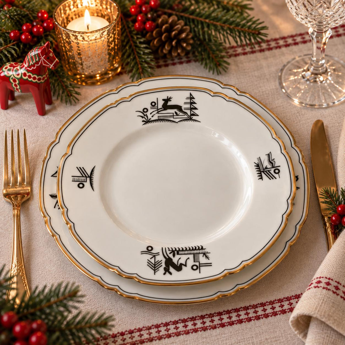 a table setting with a white plate, gold trim, and a candle, surrounded by holiday decorations such as pine branches, berries, and a small red horse figurine.