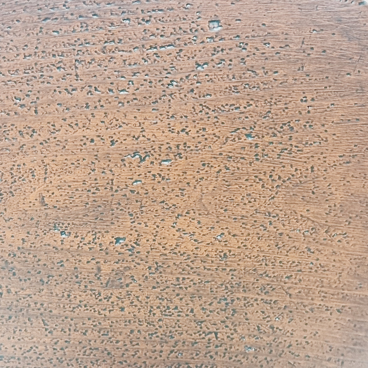 Close-up of the aged Falu red painted surface with small holes and marks