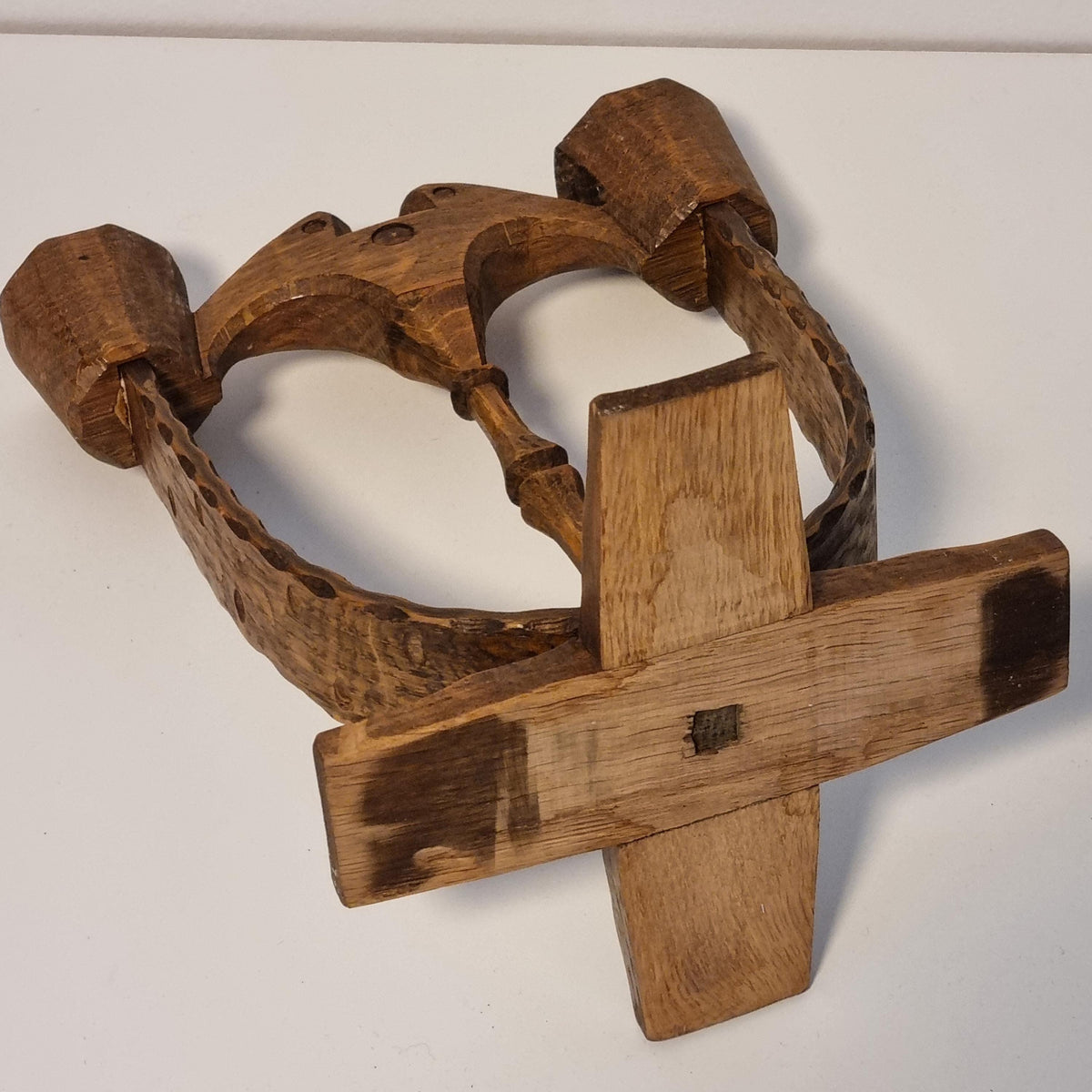 a wooden object with a cross-shaped design, which appears to be a piece of furniture or a decorative item.