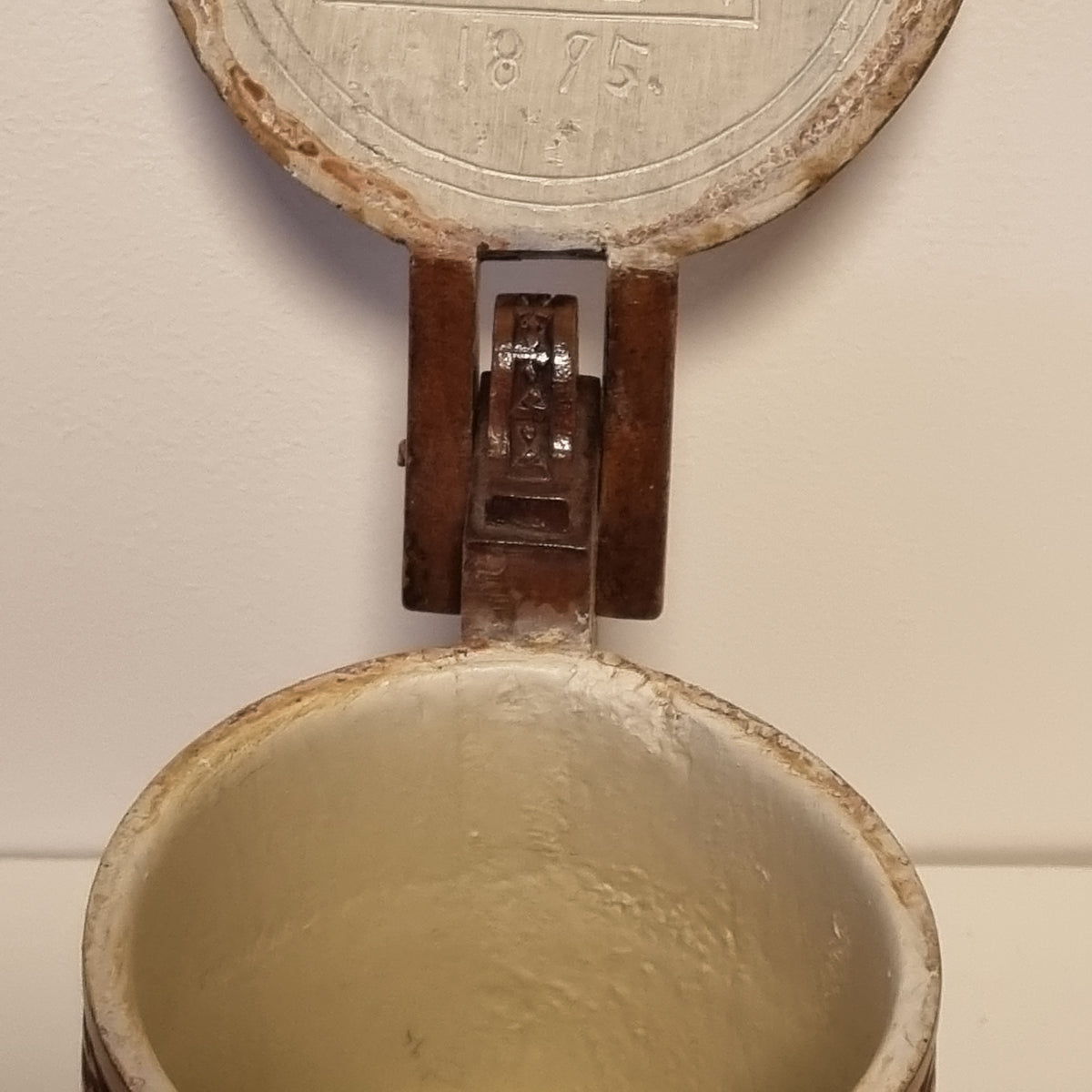 Open lid of carved wooden tankard showing later white painted interior