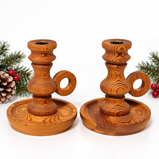 Pair of turned wooden candle holders with ring handles, honey-brown