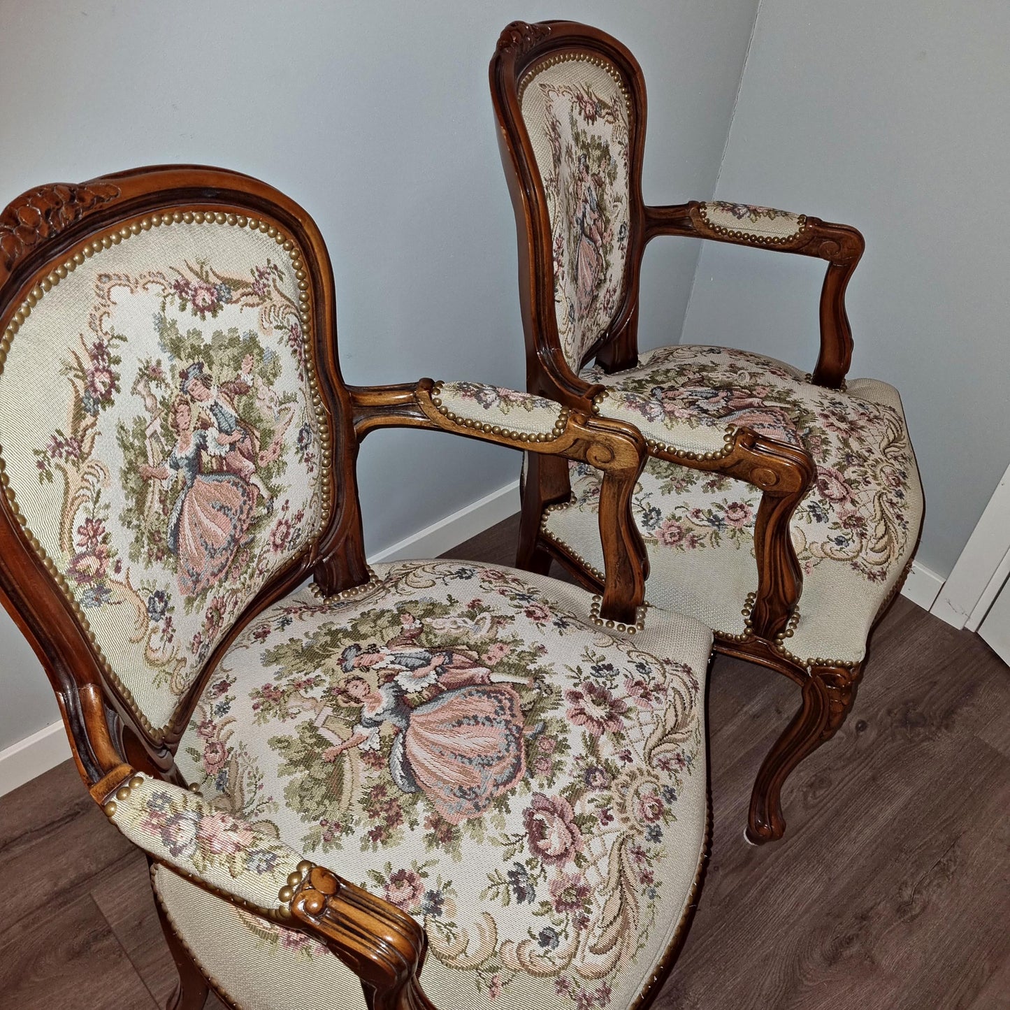 Two ornate wooden armchairs with floral needlepoint fabric featuring romantic scenes from Louis XV–Style Dining Set | Extendable table with 4 Needlepoint Armchairs -Rococo dining set