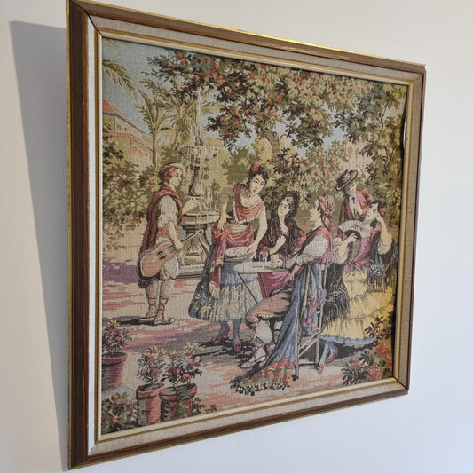 Vintage Framed Tapestry of Victorian Scene with Floral Details; Needlework depicting people in period attire outdoors under trees and near flowers