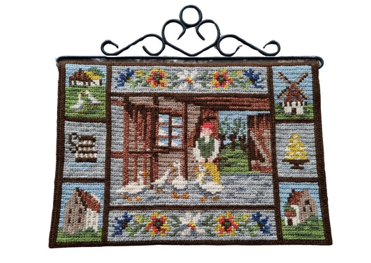 Vintage Swedish embroidered wall hanging of Nils Holgersson with his goose, iron hanger