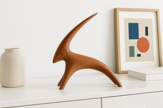 Vintage Carved Wood Goat Sculpture: Swedish MCM Organic Modern Decor displayed on white cabinet with minimalist art and vase