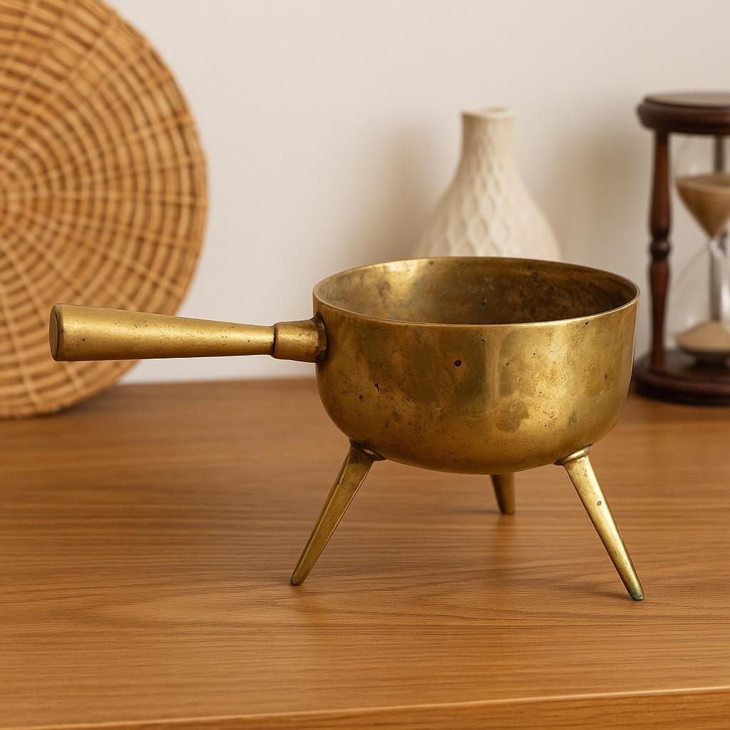 Antique Swedish Bronze Cauldron: Rustic Farmhouse Decor, Three-Legged Pot on wooden table with woven and ceramic decor