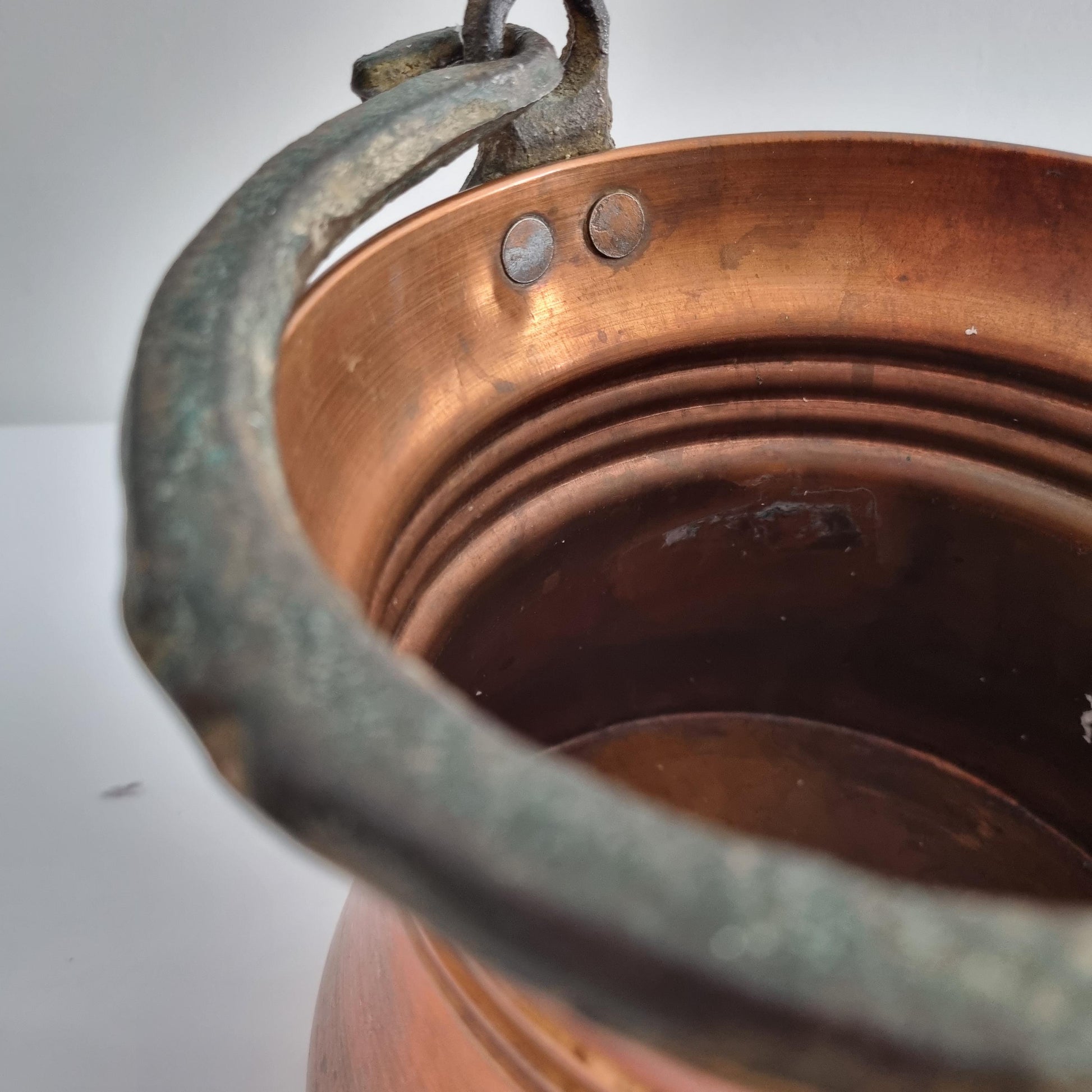 Antique Copper Bucket: Rustic Farmhouse Cauldron with Iron Handle showing close-up of copper interior and weathered iron handle