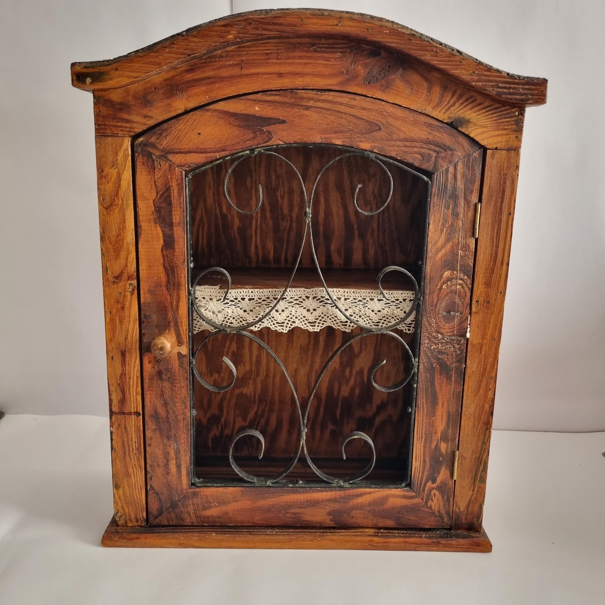 Antique Rustic Wood Wall Cabinet with Iron Door: Farmhouse Kitchen Storage featuring decorative metal scrollwork and lace shelf lining.