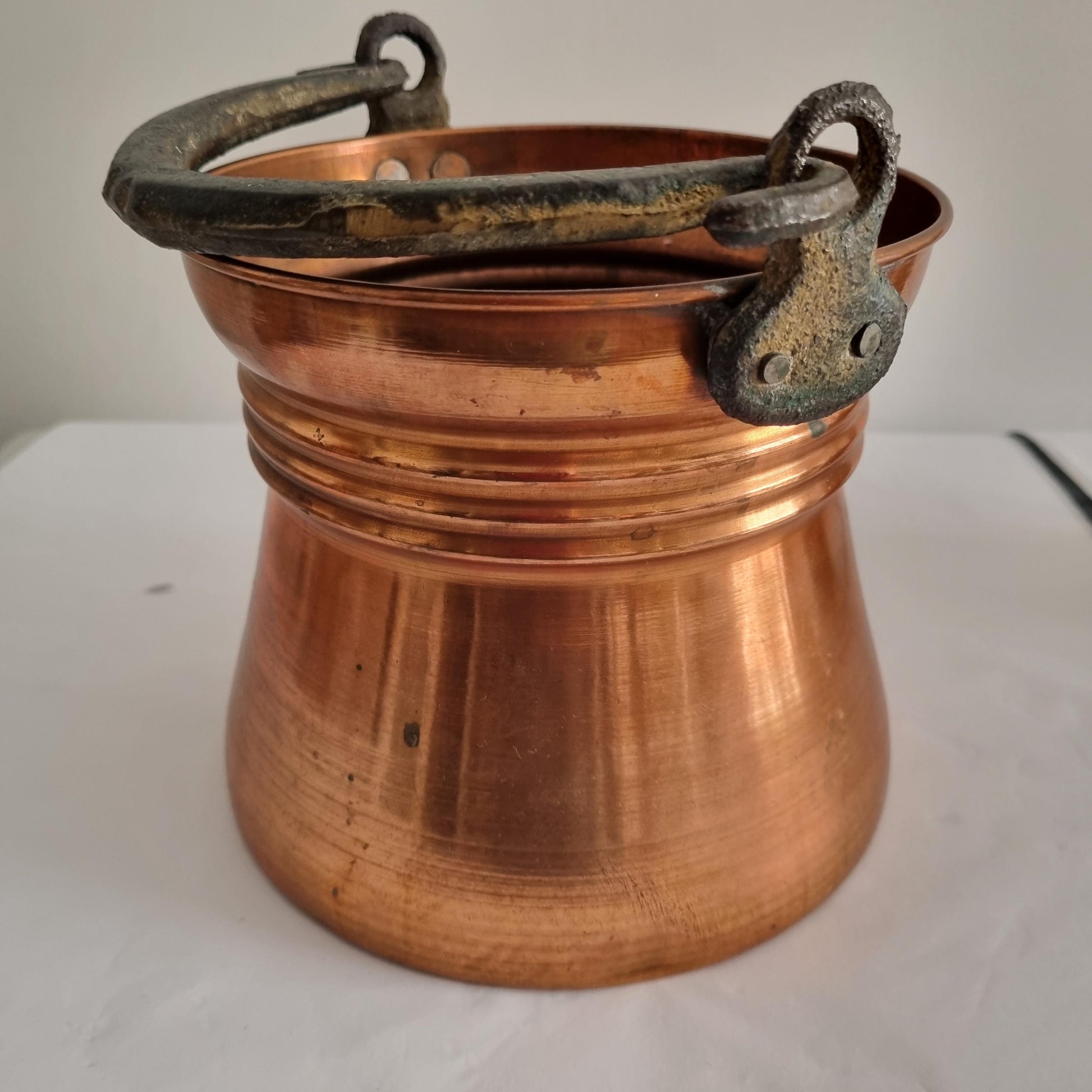 Antique Copper Bucket: Rustic Farmhouse Cauldron with Iron Handle showing classic aged copper and worn iron handle details.