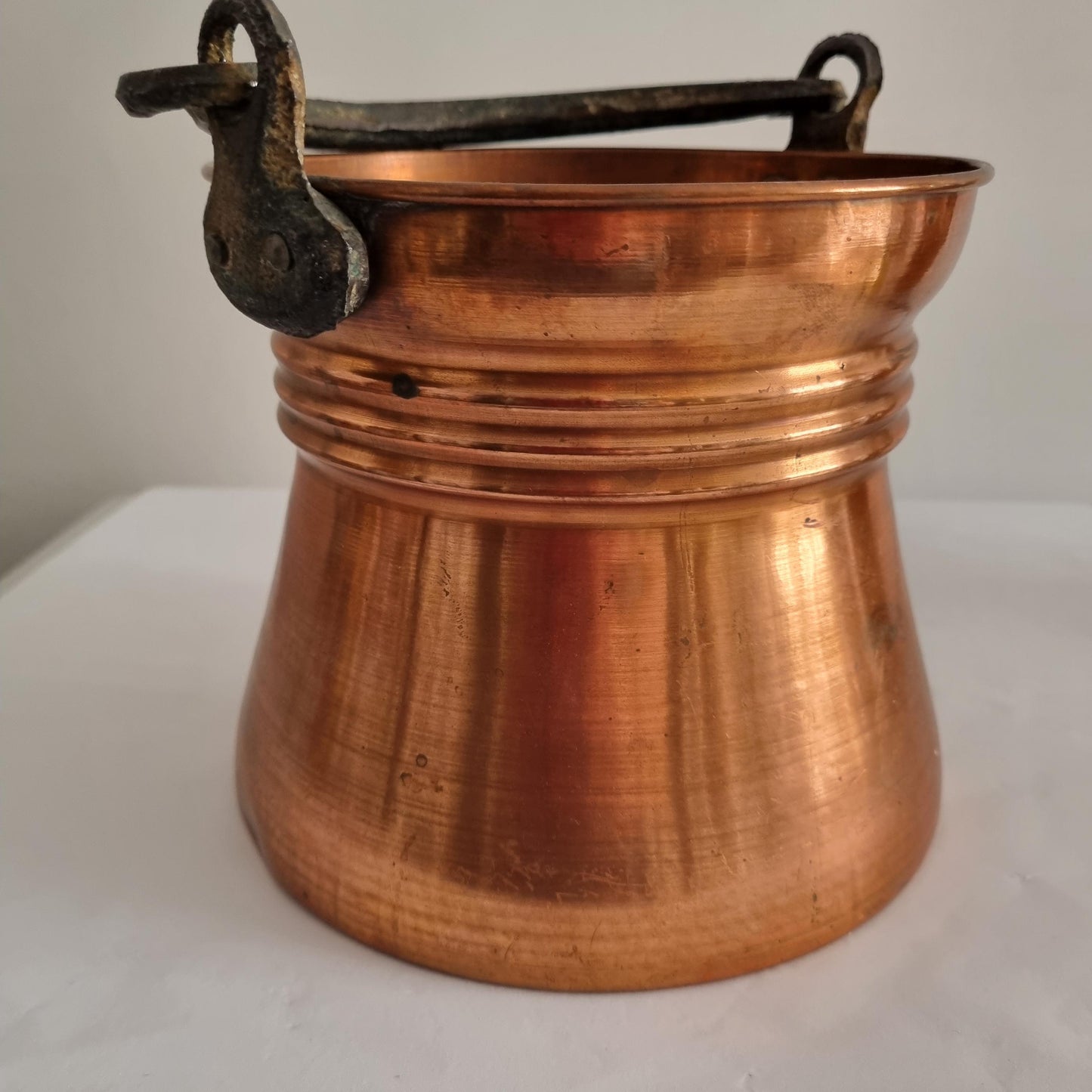 Antique Copper Bucket: Rustic Farmhouse Cauldron with Iron Handle showing hammered copper texture and sturdy iron handle