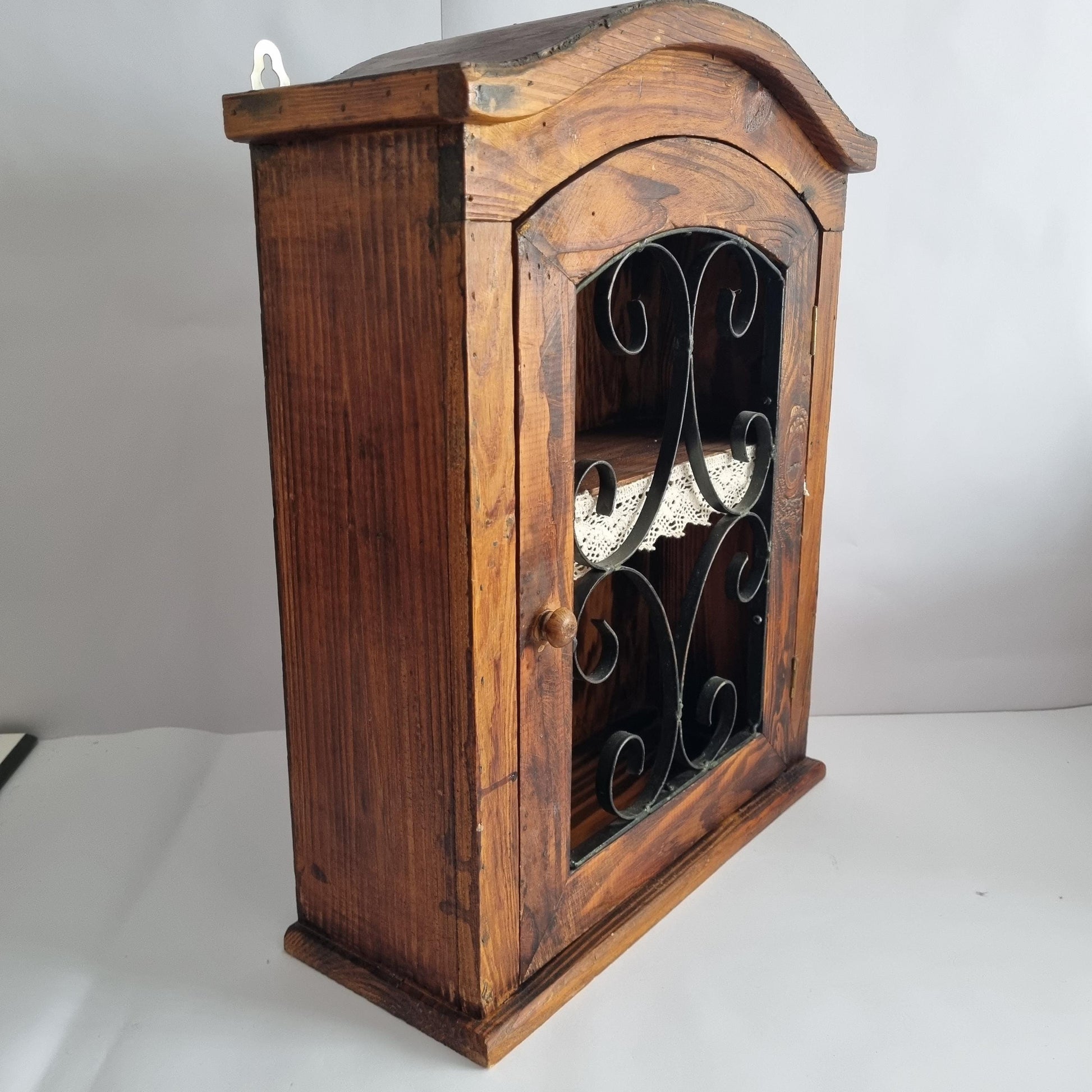 Antique Rustic Wood Wall Cabinet with Iron Door: Farmhouse Kitchen Storage featuring wrought iron scrollwork and warm wood tones