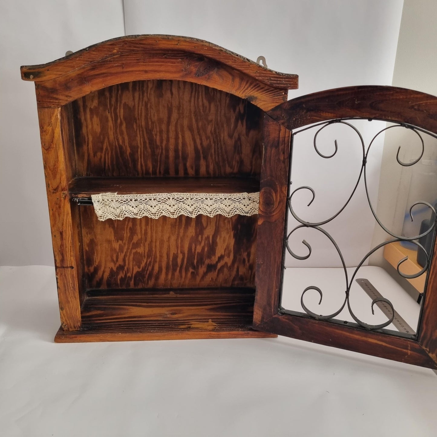Antique Rustic Wood Wall Cabinet with Iron Door: Farmhouse Kitchen Storage showing open door with decorative iron scrollwork and interior shelf.