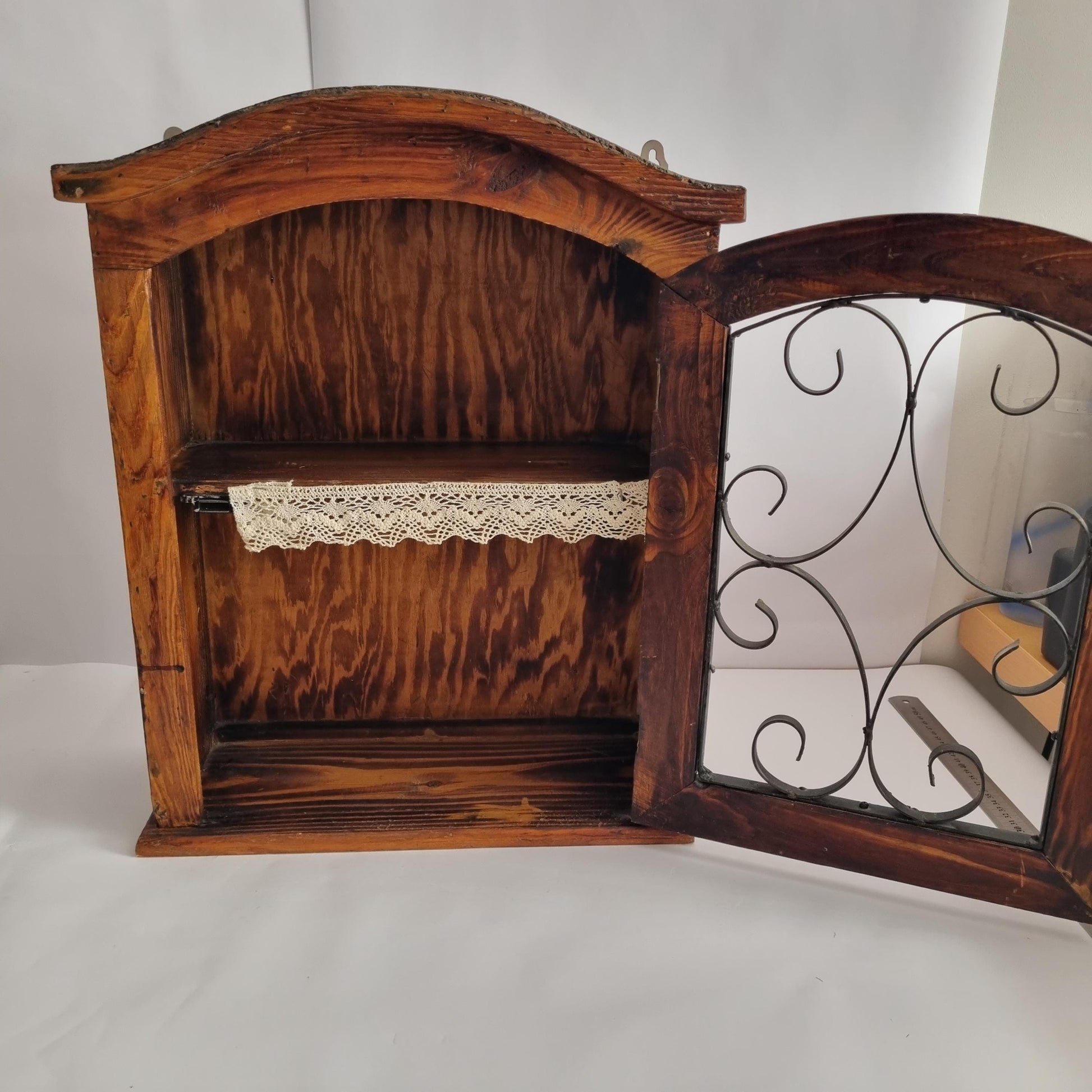 Antique Rustic Wood Wall Cabinet with Iron Door: Farmhouse Kitchen Storage showing open door with decorative iron scrollwork and interior shelf.