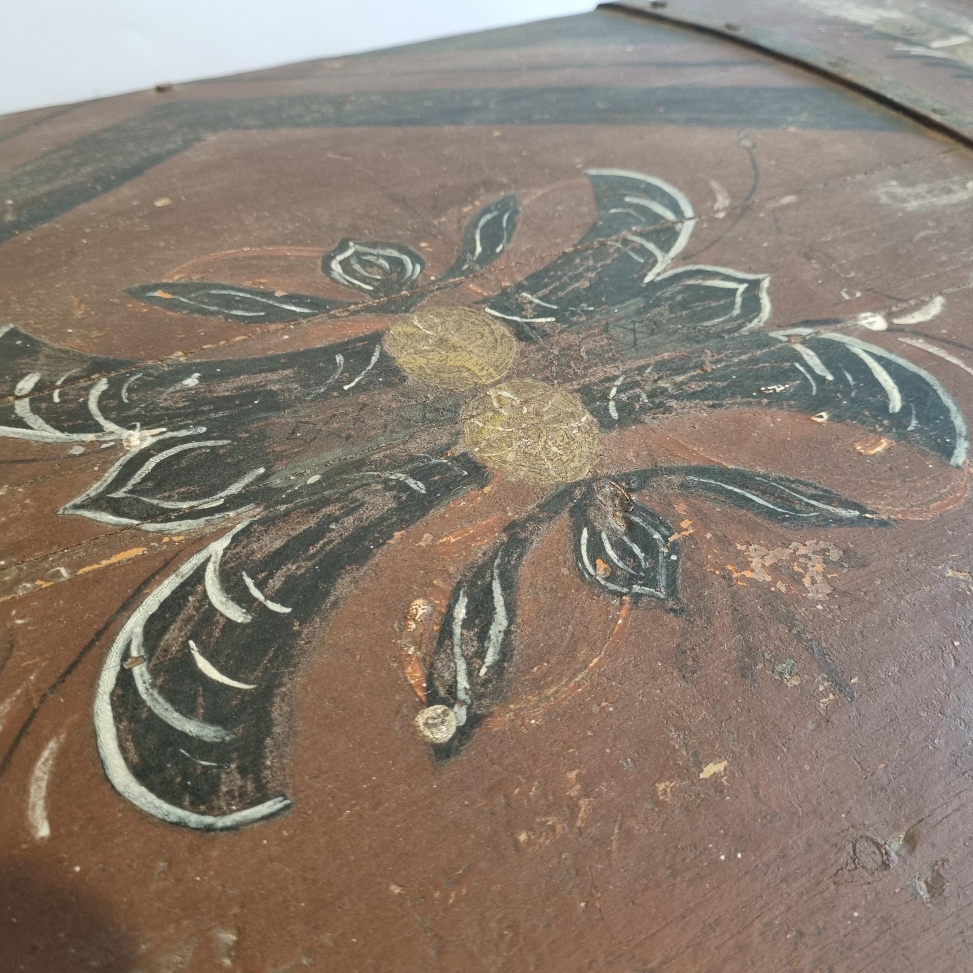 Close-up detail of floral folk art painting on Antique Swedish Kurbits Chest: 1854 Dalarna Folk Art Painted Trunk surface