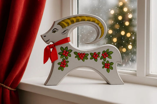 Hand-Painted Wooden Yule Goat: Signed Scandinavian Christmas Decor with floral design and red bow, timeless charm, authentic vintage piece.