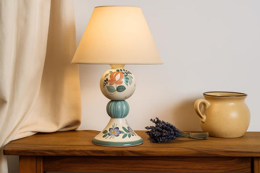 Hand-Painted Swedish Ceramic Table Lamp – Folk Art Charm with floral design on wooden table and ceramic jug nearby